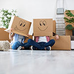 children with moving boxes on their head that are decorated with silly faces 